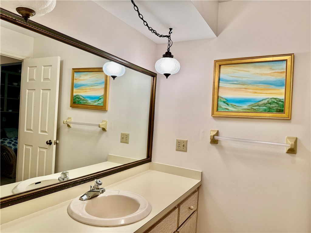 1946 Surfside Terrace Vero Beach, FL 32963 - Photo 28 of 36 a bathroom with a sink a mirror and a shower