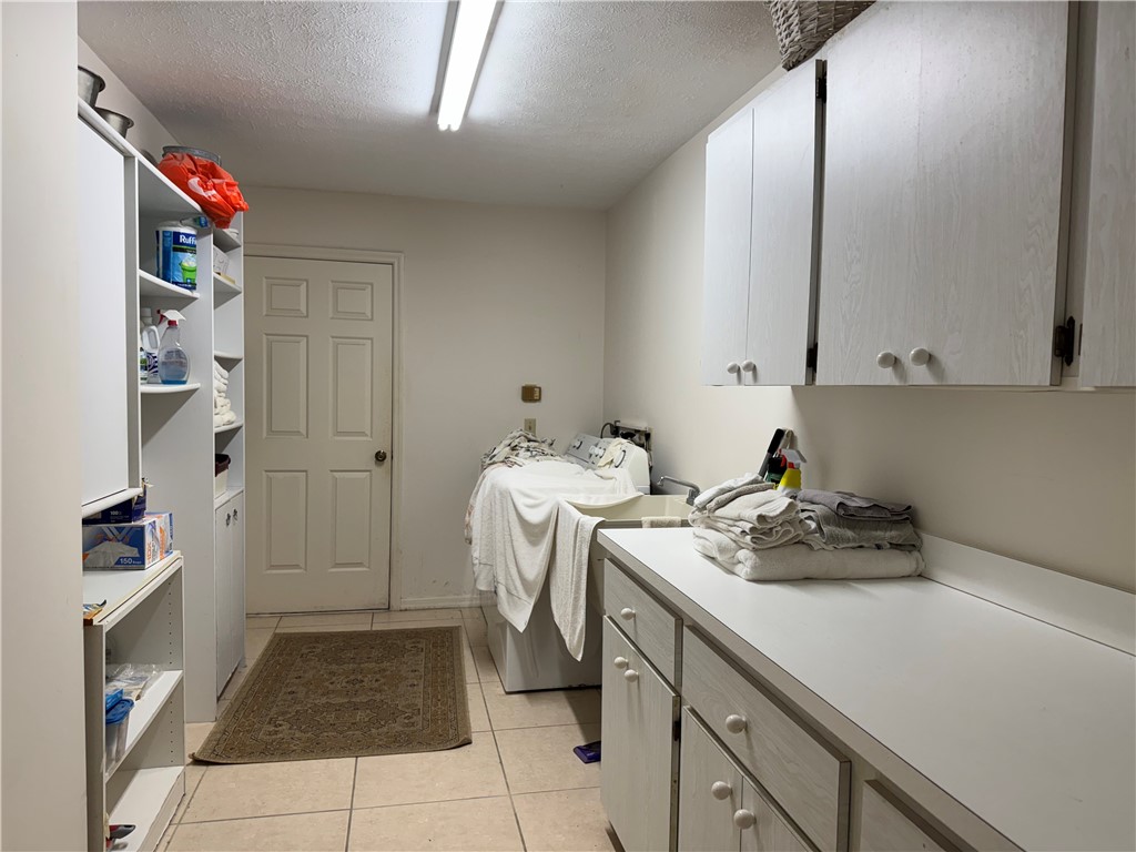 1946 Surfside Terrace Vero Beach, FL 32963 - Photo 30 of 36 a room with a washing machine and cabinets