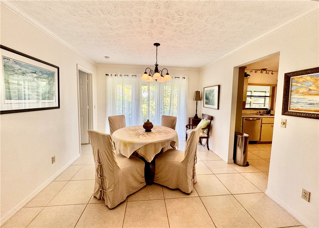 1946 Surfside Terrace Vero Beach, FL 32963 - Photo 8 of 36 a view of a dining room with furniture and a chandelier