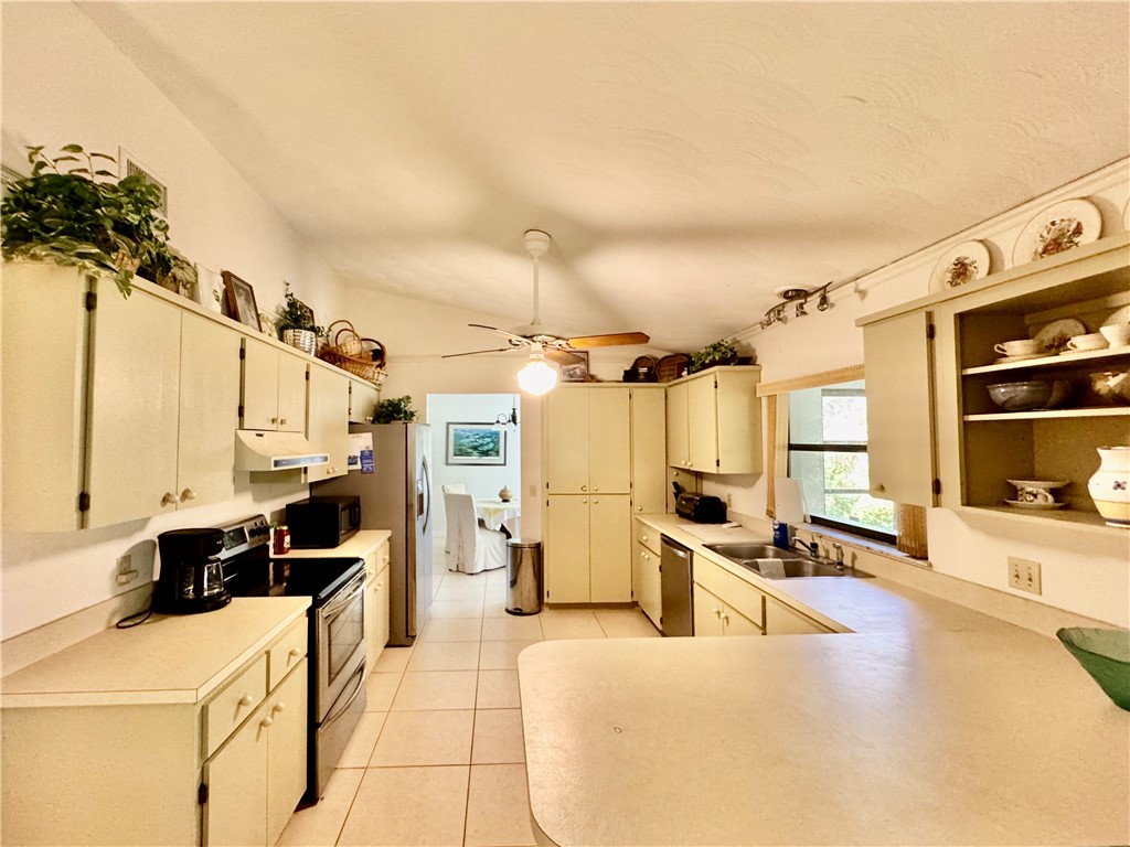 1946 Surfside Terrace Vero Beach, FL 32963 - Photo 9 of 36 a kitchen with a sink appliances and cabinets