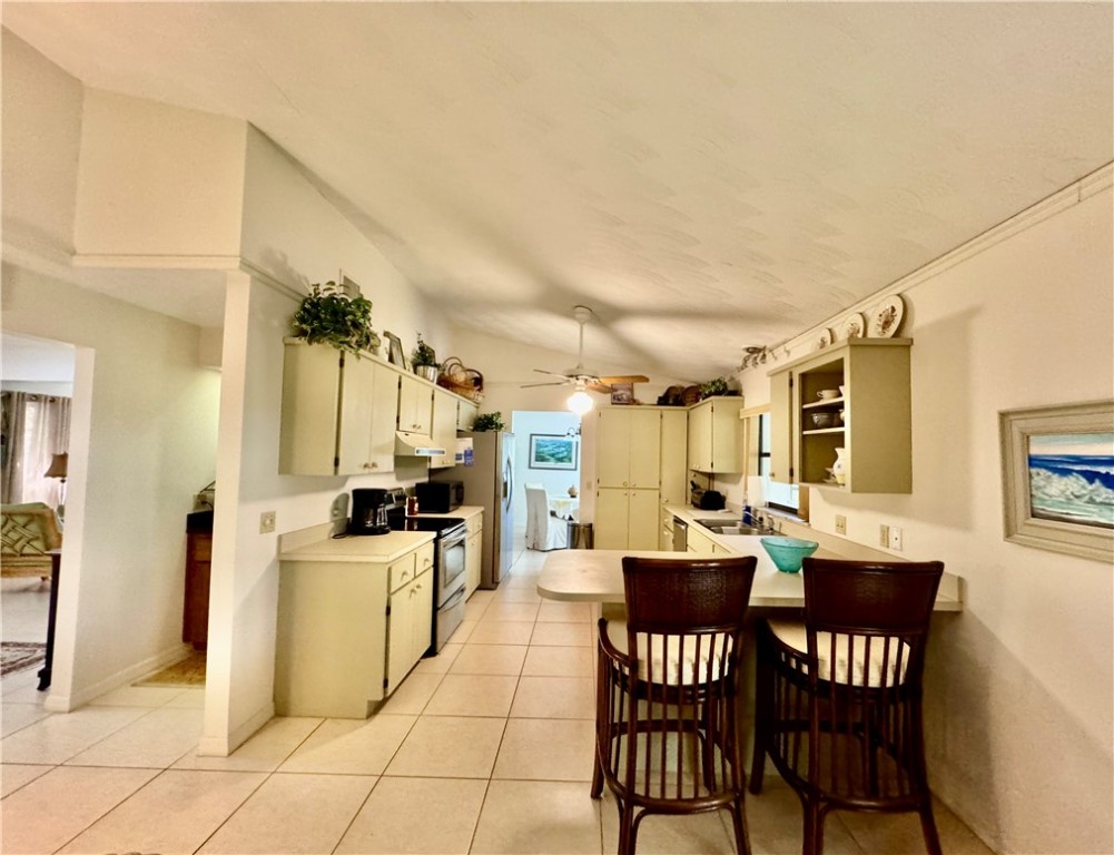1946 Surfside Terrace Vero Beach, FL 32963 - Photo 10 of 36 a view of a dining room with furniture and chandelier