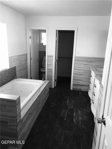 a bathroom with a sink a mirror and vanity