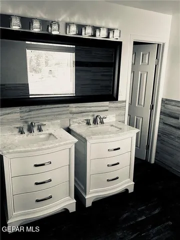 a bedroom with two beds and a chandelier