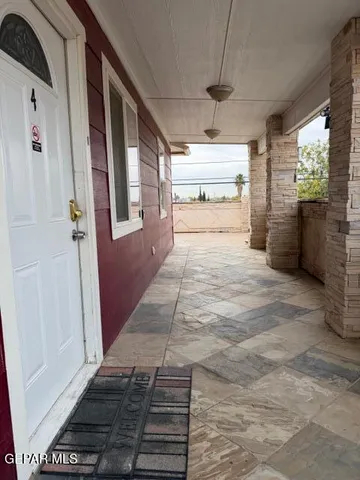 a kitchen with granite countertop wooden cabinets and a stove top oven