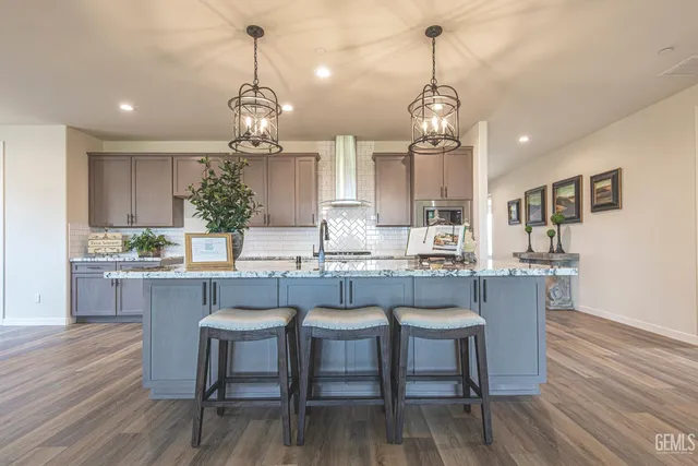 a dining room filled chandelier and wooden floor