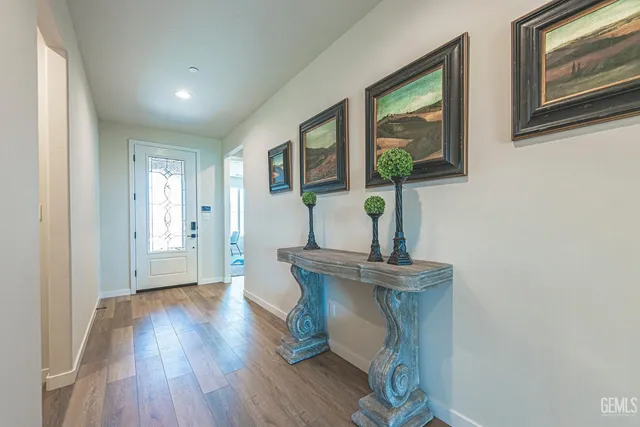 a view of a hallway with wooden floor and entryway
