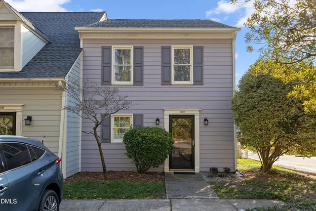 a view of a house with a yard and furniture