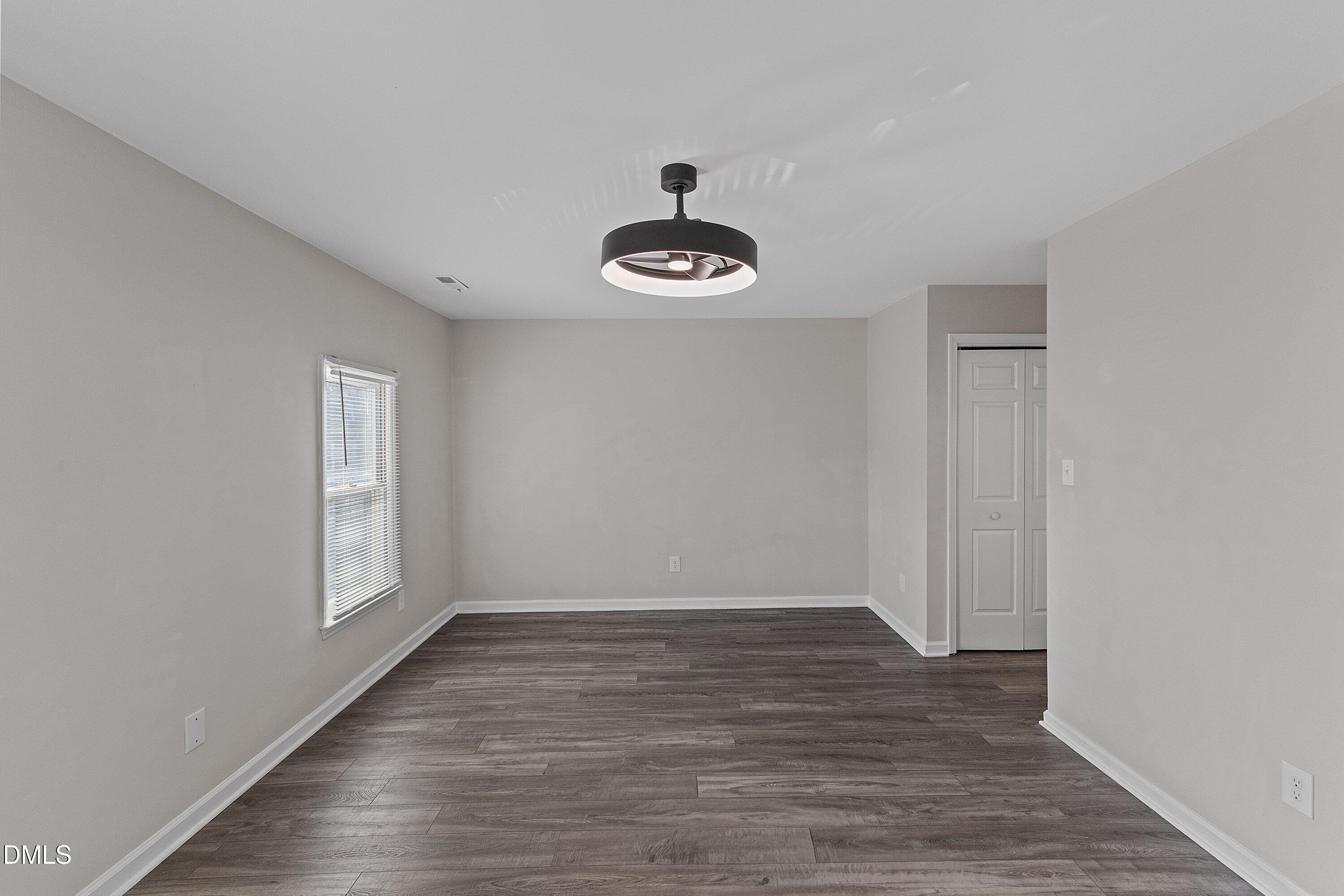 1900 Township Circle Raleigh, NC 27609 - Photo 15 of 19 a view of an empty room with wooden floor and a window