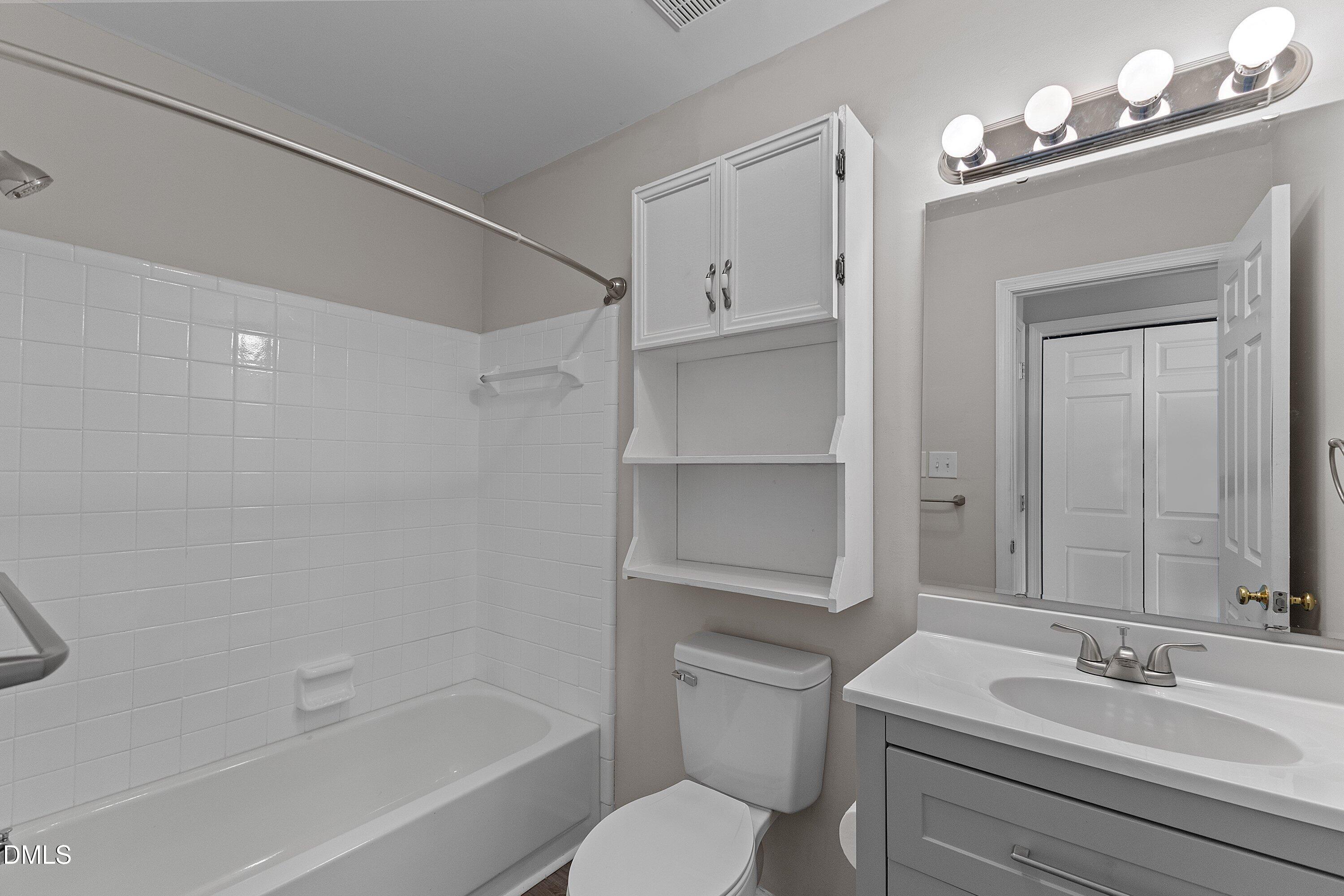 1900 Township Circle Raleigh, NC 27609 - Photo 17 of 19 a bathroom with a sink a toilet and shower