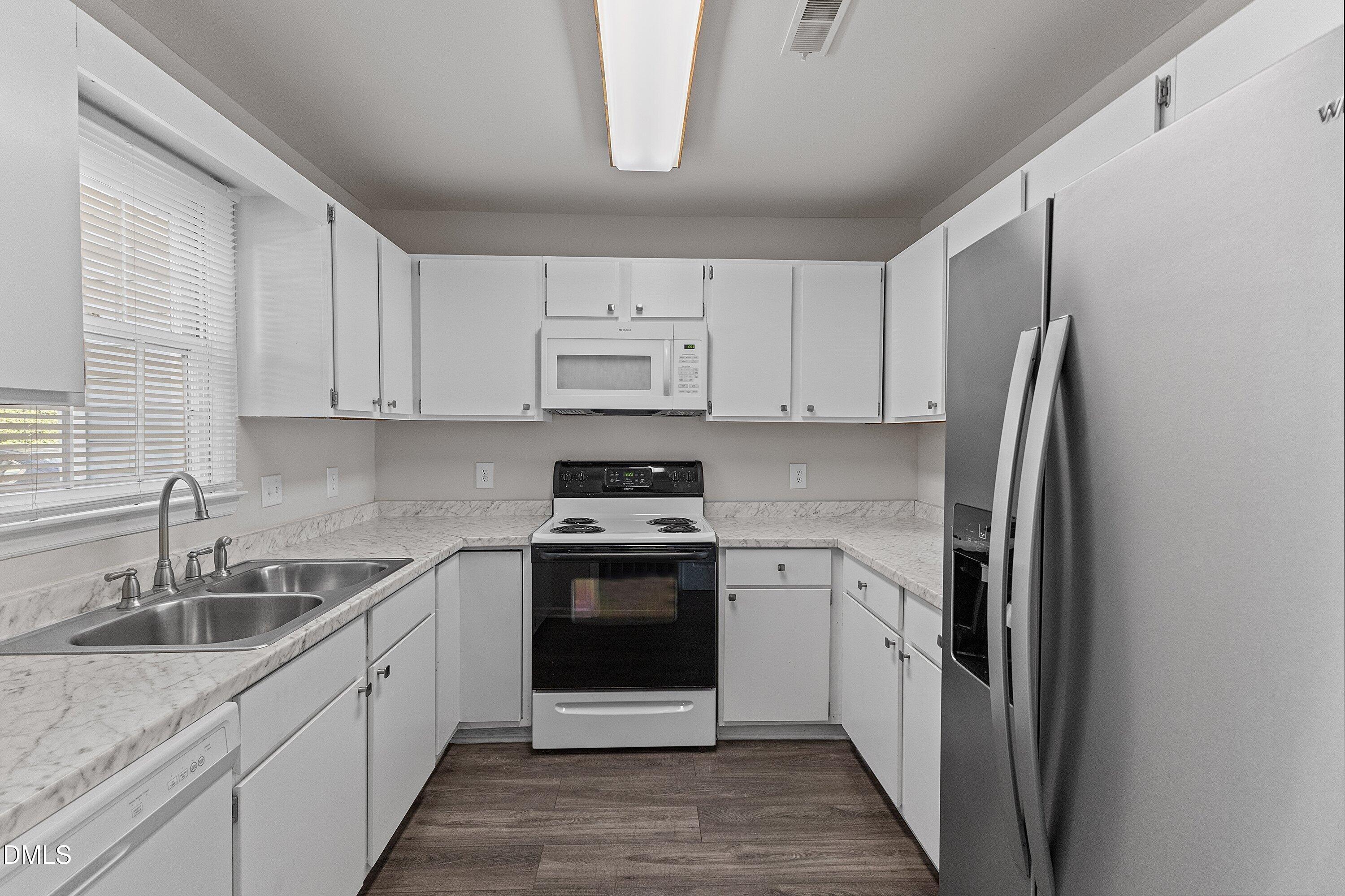1900 Township Circle Raleigh, NC 27609 - Photo 4 of 19 a kitchen with stainless steel appliances granite countertop a sink stove and refrigerator