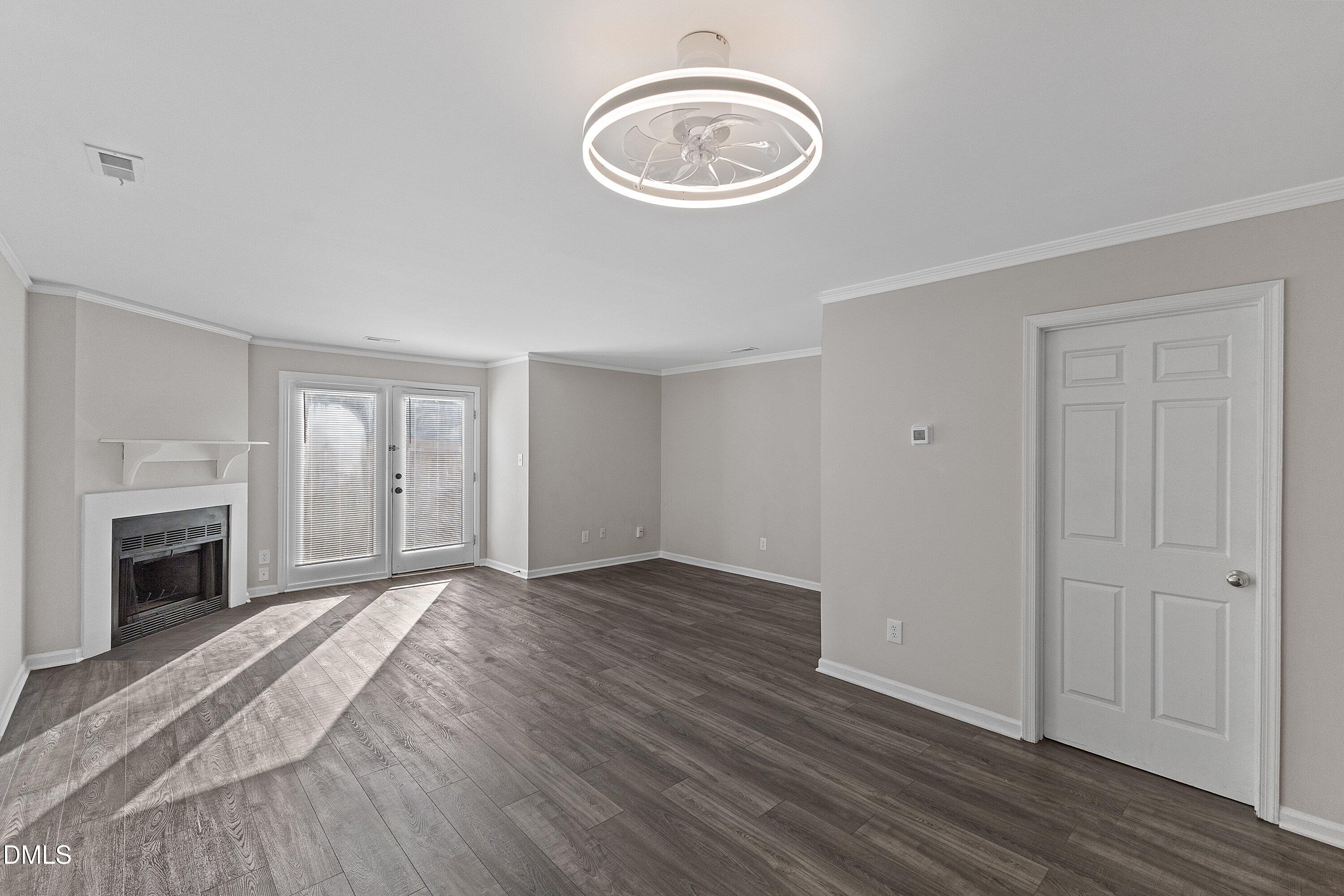 1900 Township Circle Raleigh, NC 27609 - Photo 8 of 19 a view of an empty room with wooden floor and a window