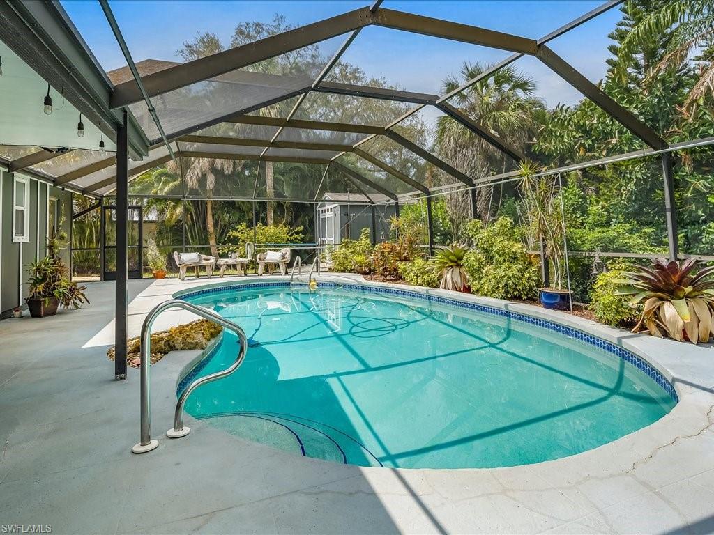 a view of a swimming pool with a bench in patio