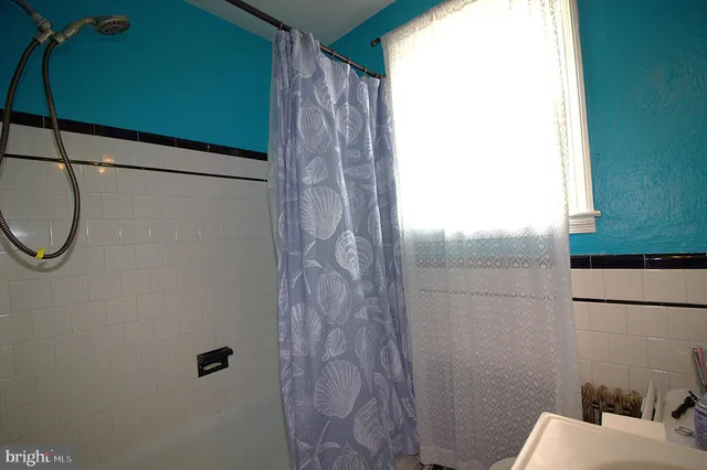 a bathroom with a shower curtain and a sink