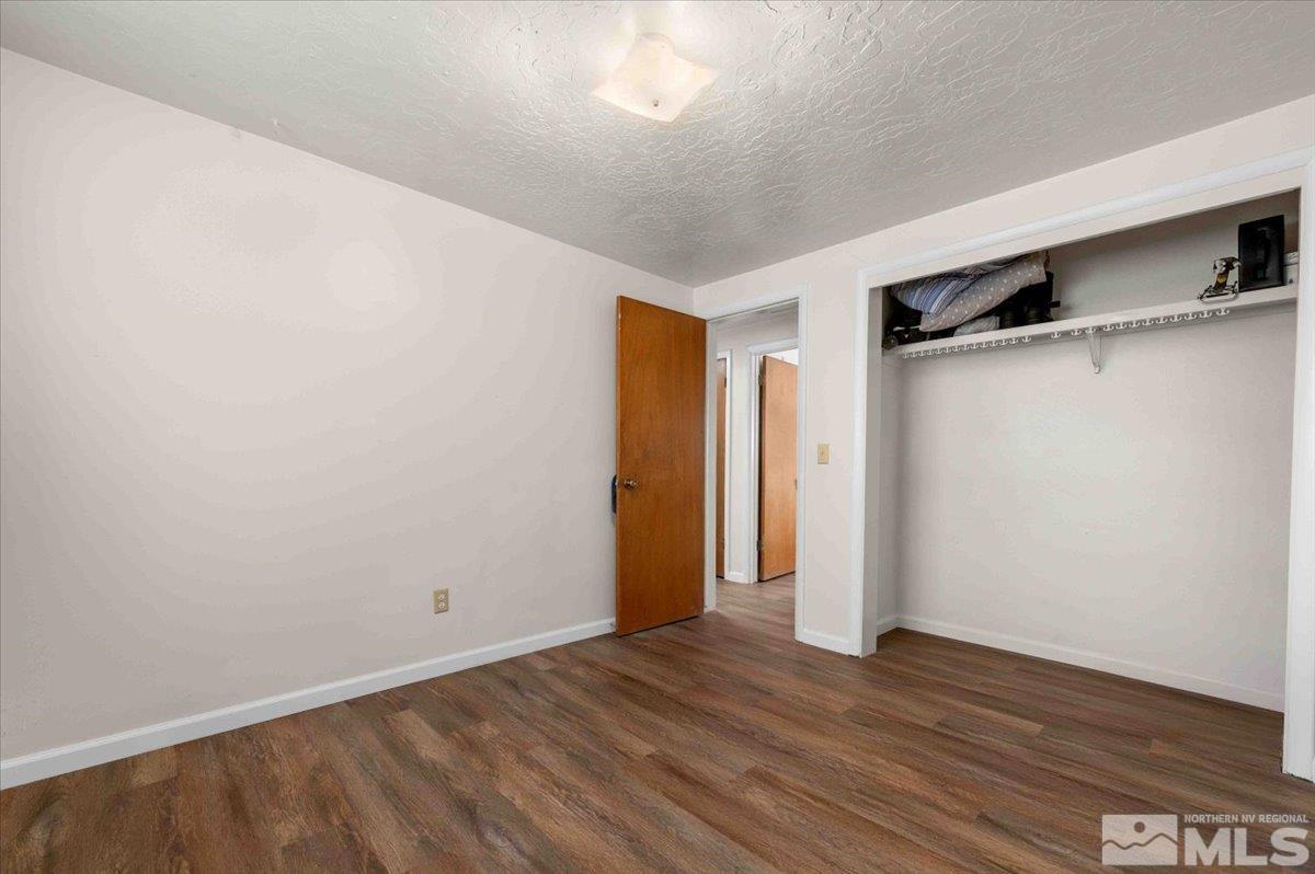 8925 Limnol Street Reno, NV 89506 - Photo 14 of 32 a view of an empty room with wooden floor