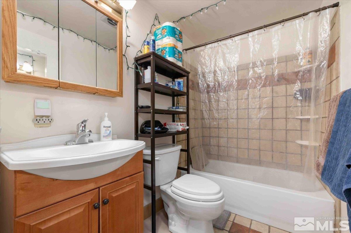 8925 Limnol Street Reno, NV 89506 - Photo 15 of 32 a bathroom with a sink a toilet and shower