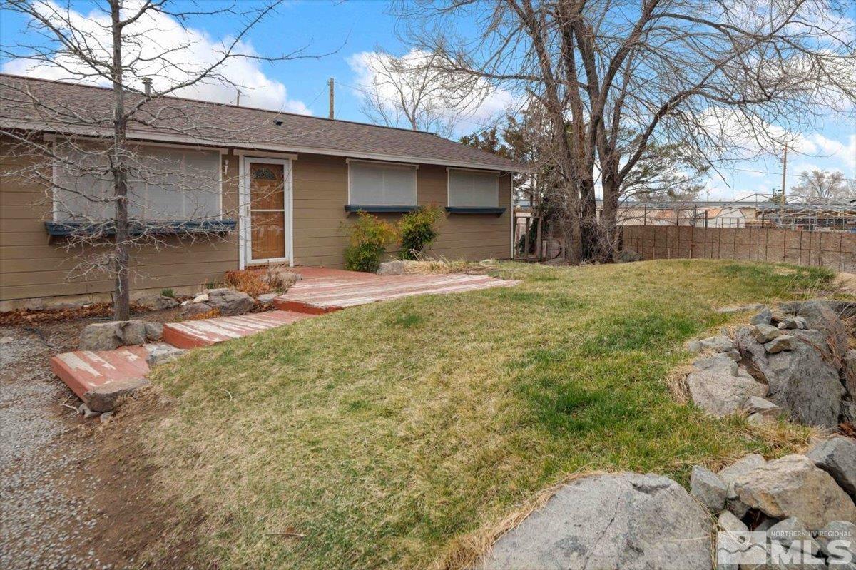 8925 Limnol Street Reno, NV 89506 - Photo 3 of 32 a front view of a house with a yard and garage