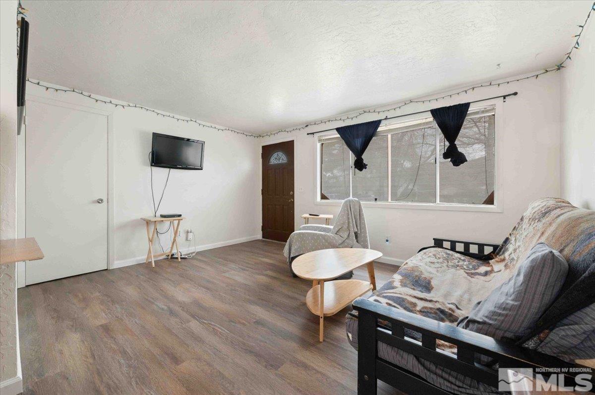 8925 Limnol Street Reno, NV 89506 - Photo 4 of 32 a living room with furniture and a flat screen tv