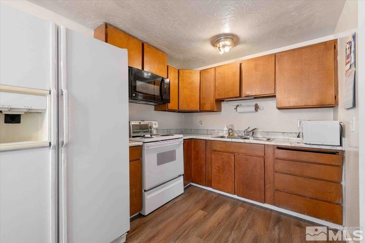 8925 Limnol Street Reno, NV 89506 - Photo 8 of 32 a kitchen with stainless steel appliances granite countertop a sink stove and refrigerator