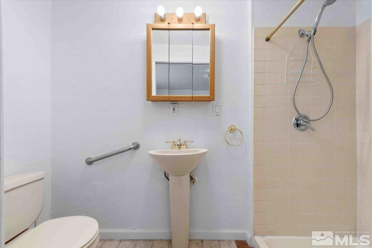 8925 Limnol Street Reno, NV 89506 - Photo 10 of 32 a bathroom with a sink a toilet and shower