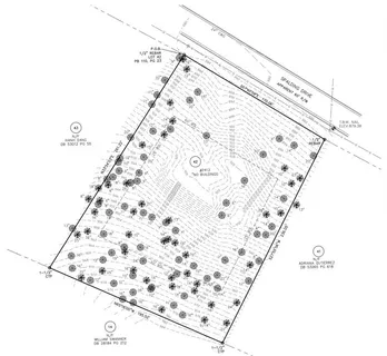 a bed with a white comforter and pillows