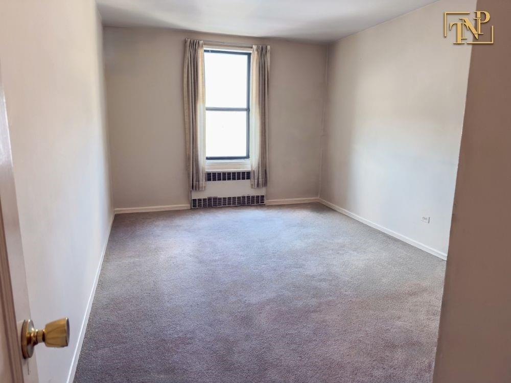 2450 Haring Street, Unit 6D Brooklyn, NY 11235 - Photo 4 of 6 an empty room with windows