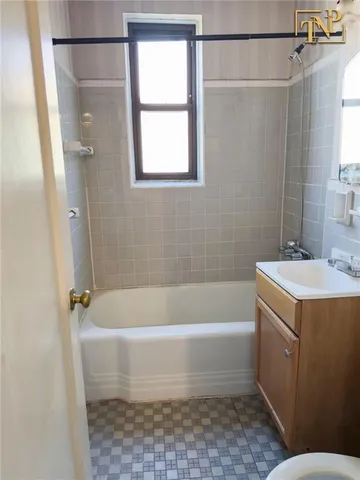 a kitchen with refrigerator and white cabinets