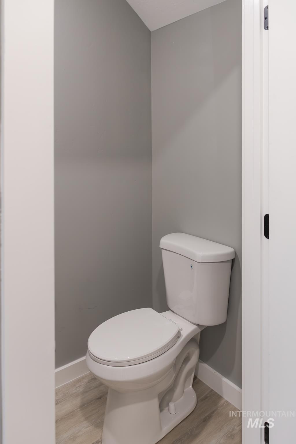 297 Southwest 6th Street, Unit 1 Ontario, OR 97914 - Photo 11 of 50 Bathroom featuring toilet and light wood-style flooring