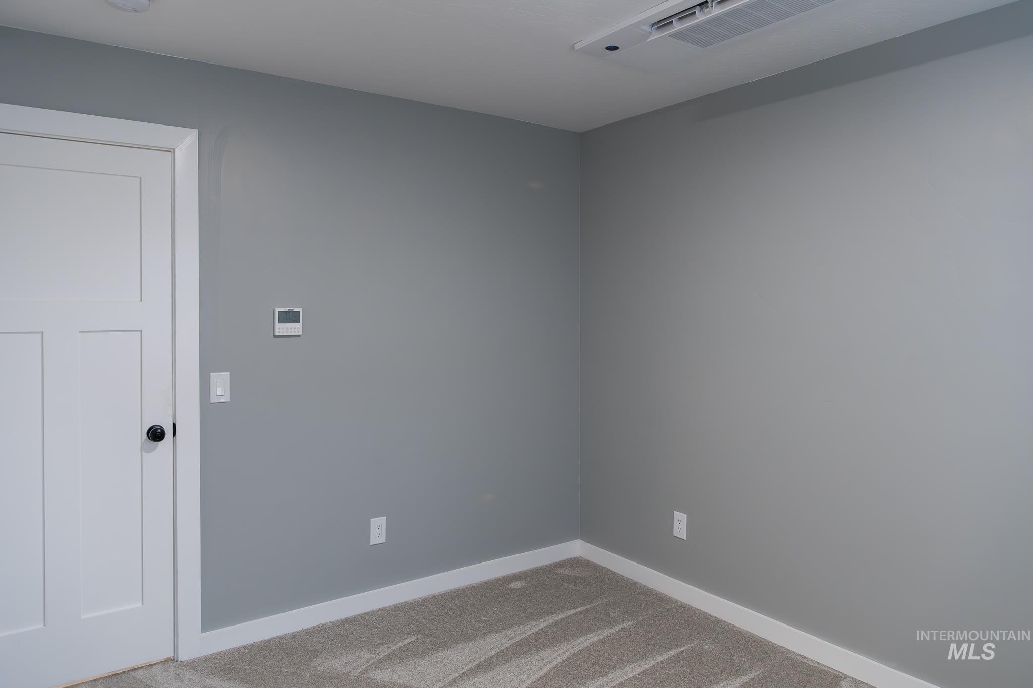 297 Southwest 6th Street, Unit 1 Ontario, OR 97914 - Photo 13 of 50 Spare room featuring baseboards and carpet