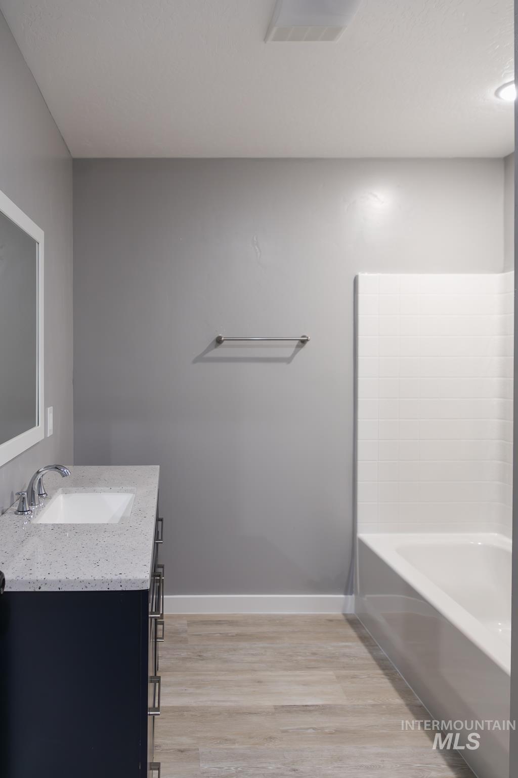 297 Southwest 6th Street, Unit 1 Ontario, OR 97914 - Photo 28 of 50 Full bath featuring vanity, light wood finished floors, and shower / bath combination