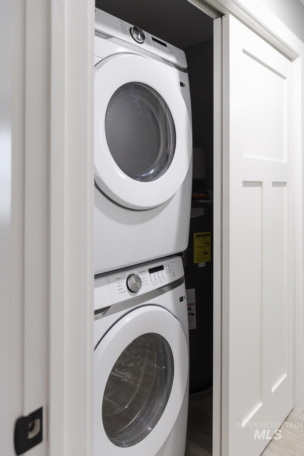 297 Southwest 6th Street, Unit 1 Ontario, OR 97914 - Photo 35 of 50 Laundry area with stacked washer and clothes dryer and light wood-type flooring