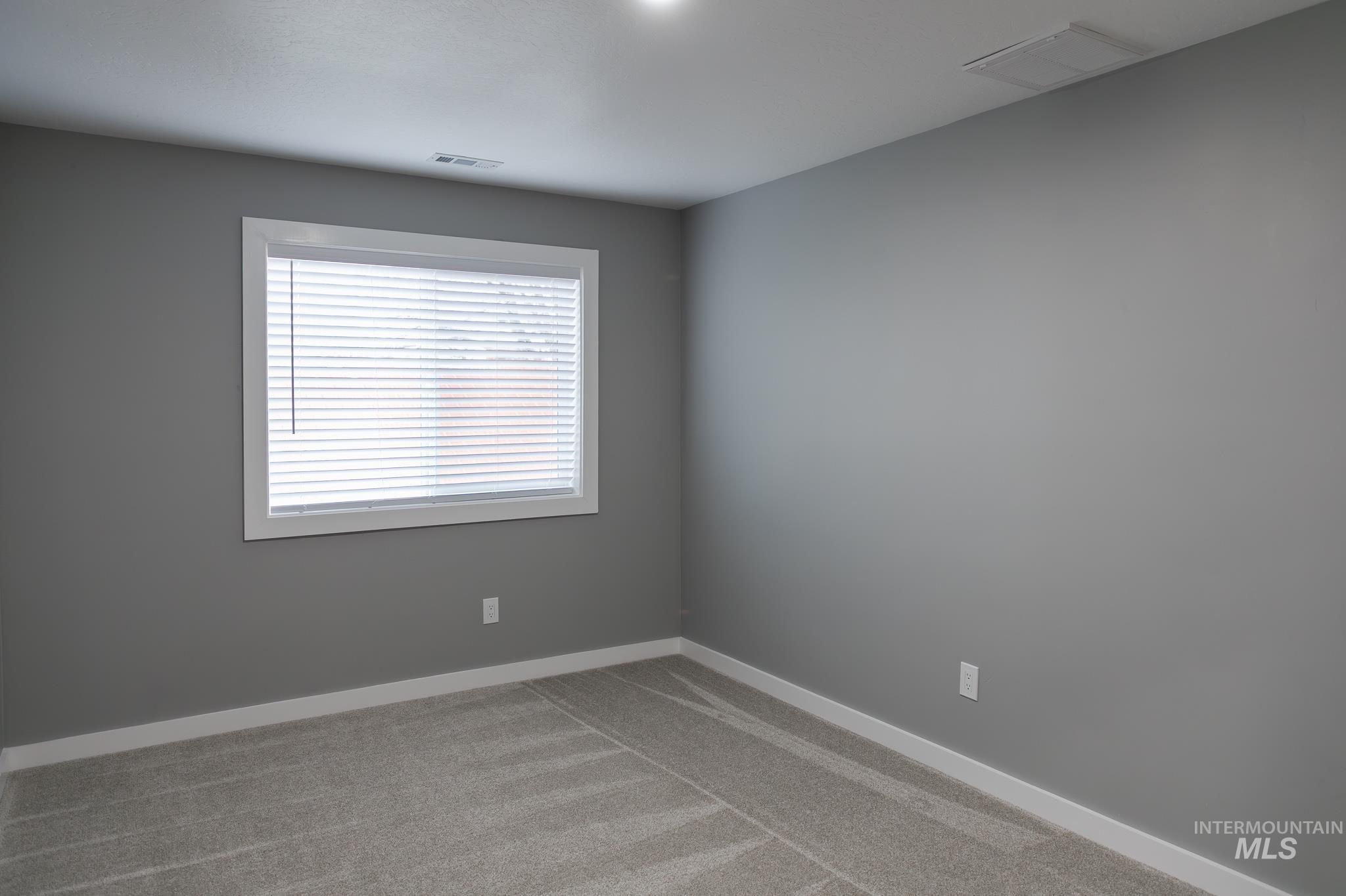 297 Southwest 6th Street, Unit 1 Ontario, OR 97914 - Photo 37 of 50 Empty room with light carpet and baseboards