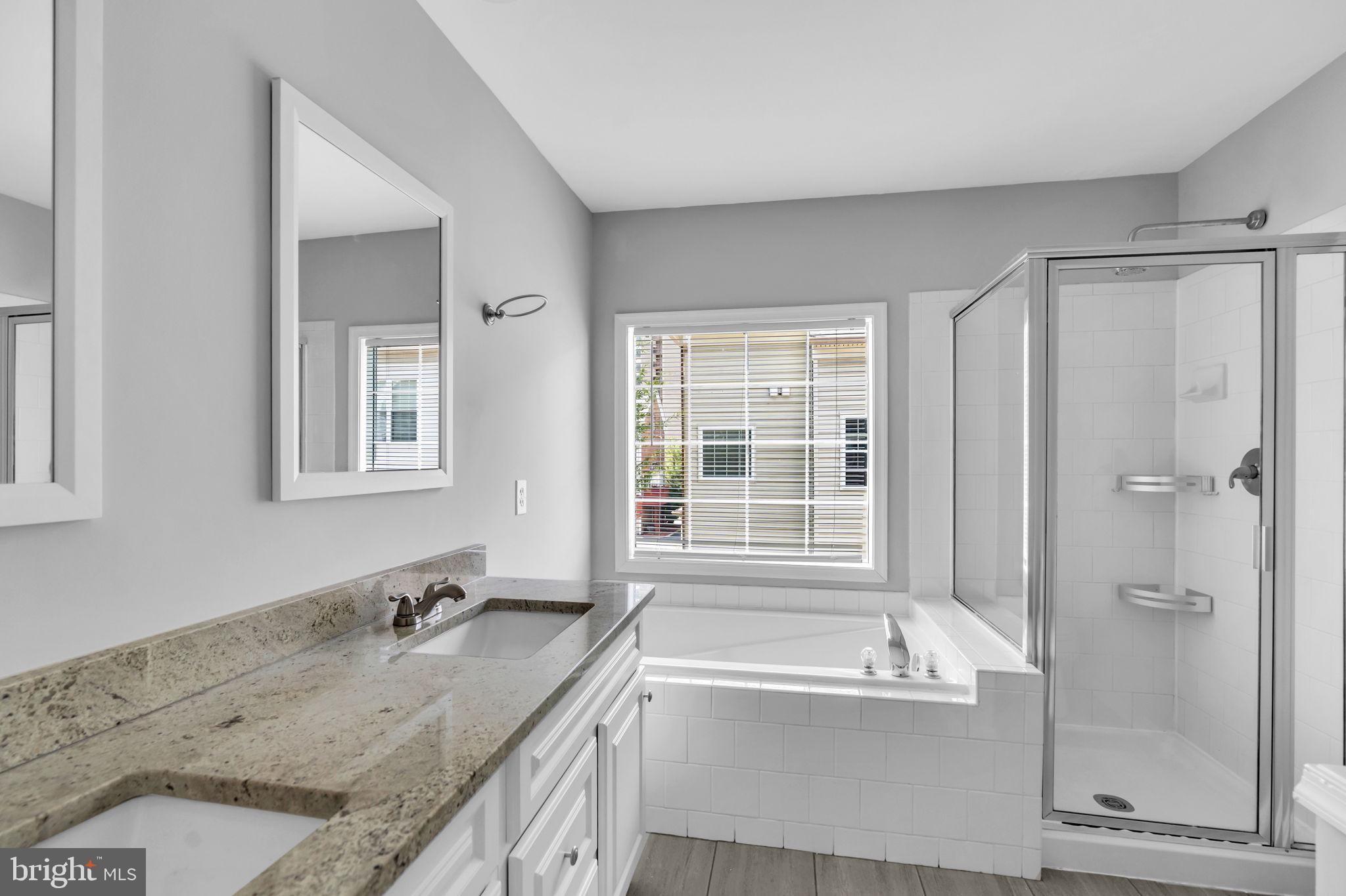 6013 Riddle Walk Alexandria, VA 22312 - Photo 18 of 31 a bathroom with a granite countertop sink mirror and a bath tub