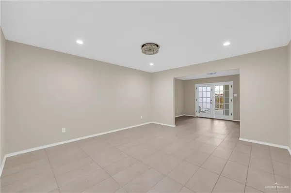 an empty room with windows and mirror