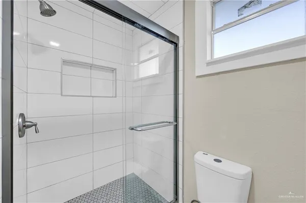 a bathroom with a shower and toilet