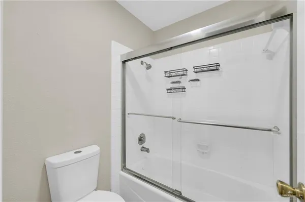 a white toilet sitting next to a bath tub