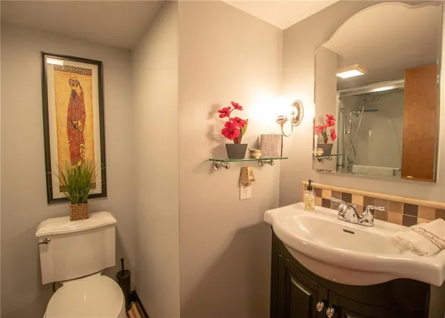 a bathroom with a sink mirror and toilet
