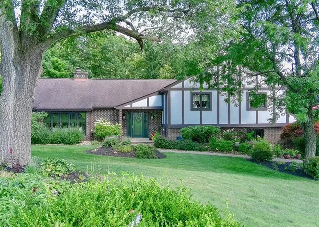 a view of a house with a yard and a garden