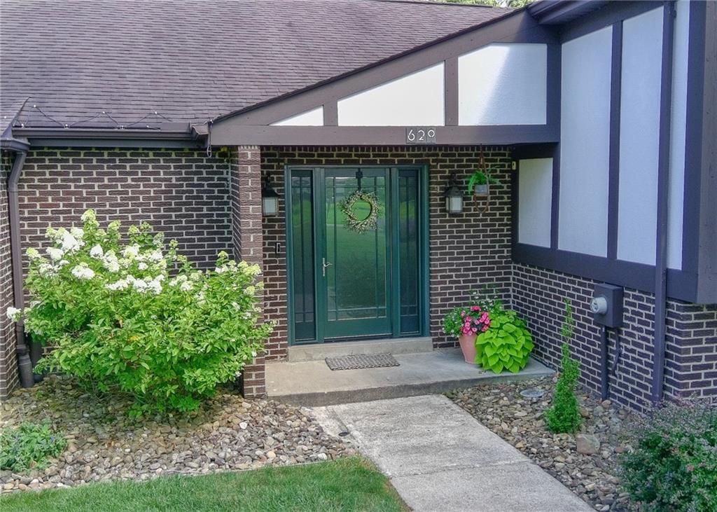 620 Timberline Lane New Stanton, PA 15672 - Photo 3 of 37 a front view of a house with a garden