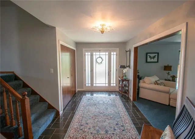 a living room with furniture and a chandelier