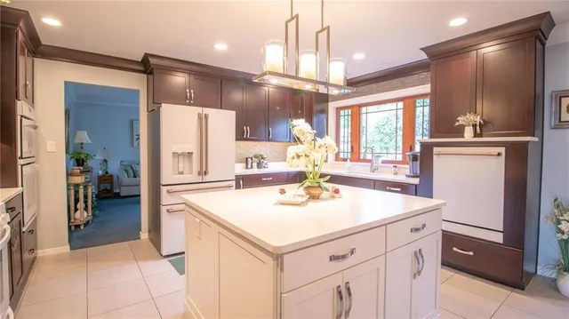 a kitchen with a sink refrigerator and cabinets