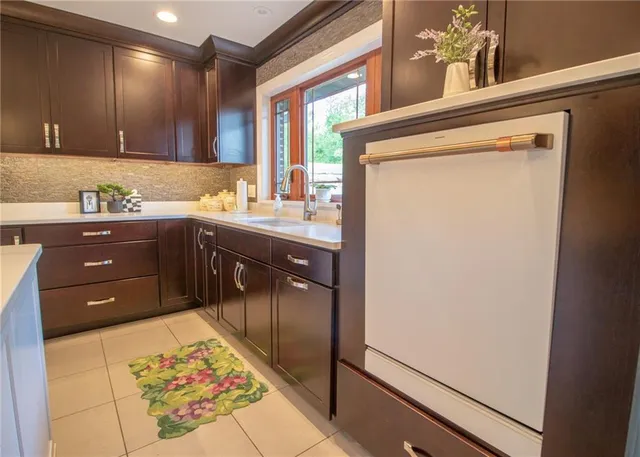 a kitchen with stainless steel appliances granite countertop a refrigerator and a stove