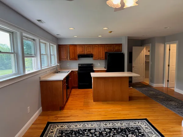 a kitchen with stainless steel appliances a stove a sink and a microwave