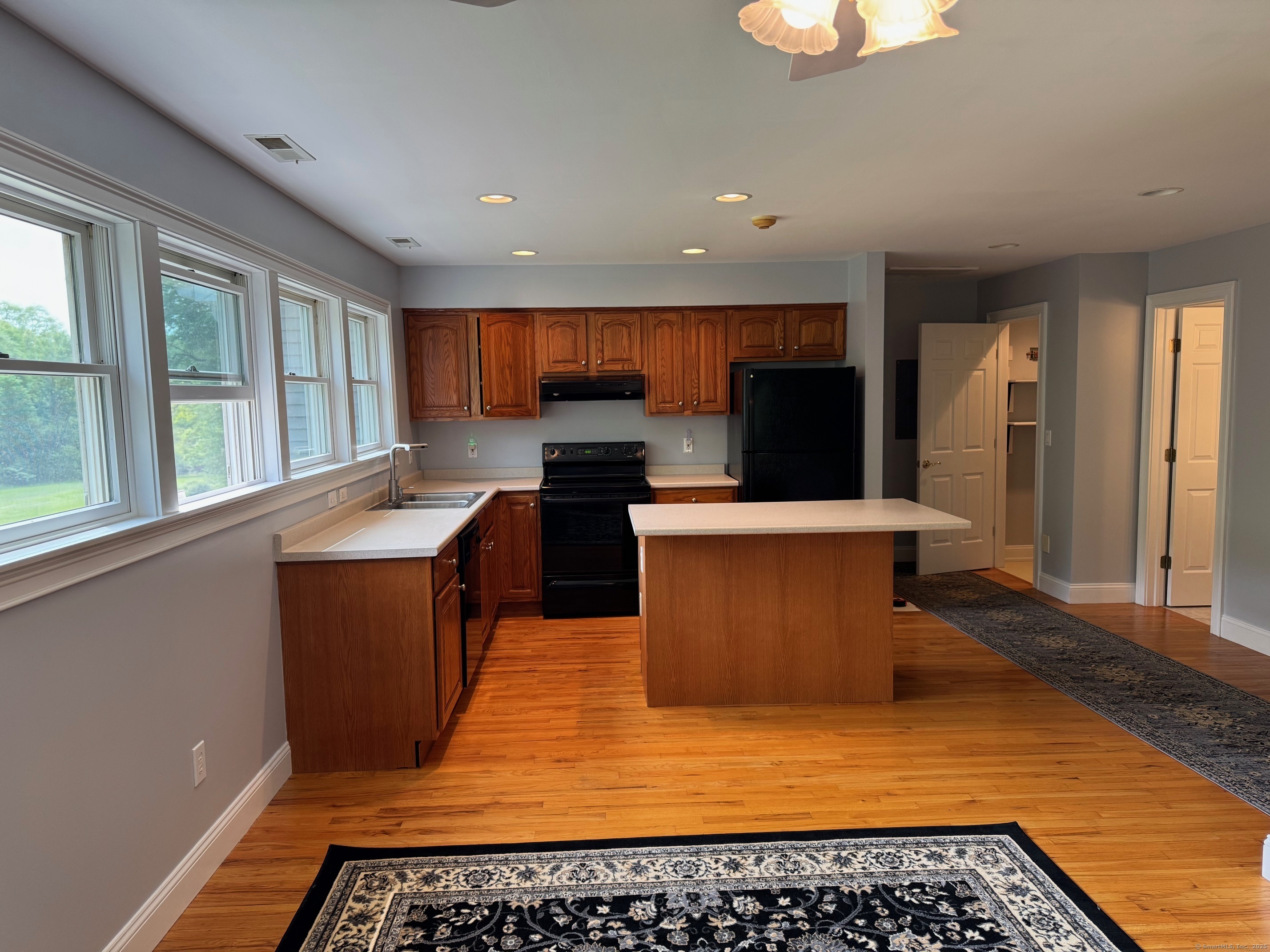 21 Highway 39, Unit A Sherman, CT 06784 - Photo 6 of 15 a kitchen with stainless steel appliances a stove a sink and a microwave