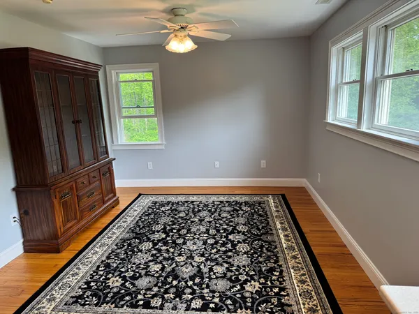 a view of a room with window and hardwood floor