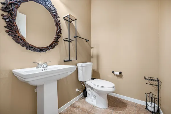 a bathroom with a sink mirror toilet and a mirror