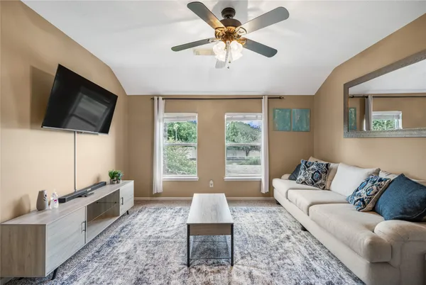 a living room with furniture and a flat screen tv