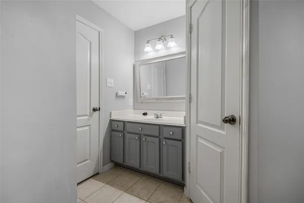 a spacious bathroom with a double vanity sink a mirror and a bathtub