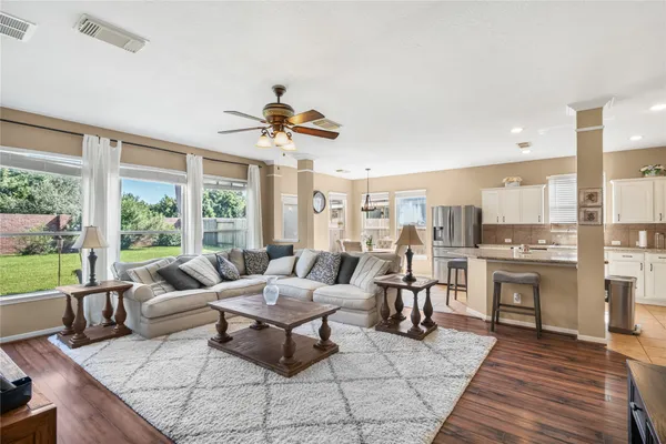 a living room with furniture and a view of kitchen