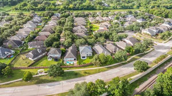 an aerial view of residential houses with outdoor space and street view