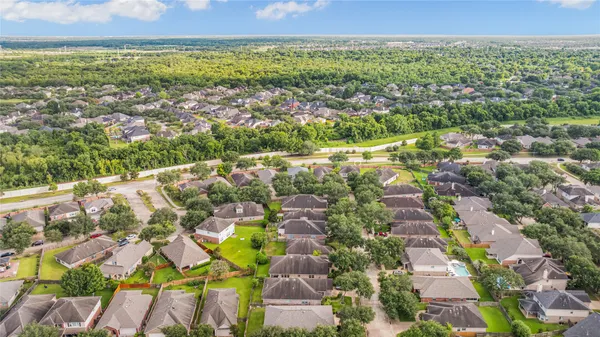 an aerial view of residential houses with outdoor space